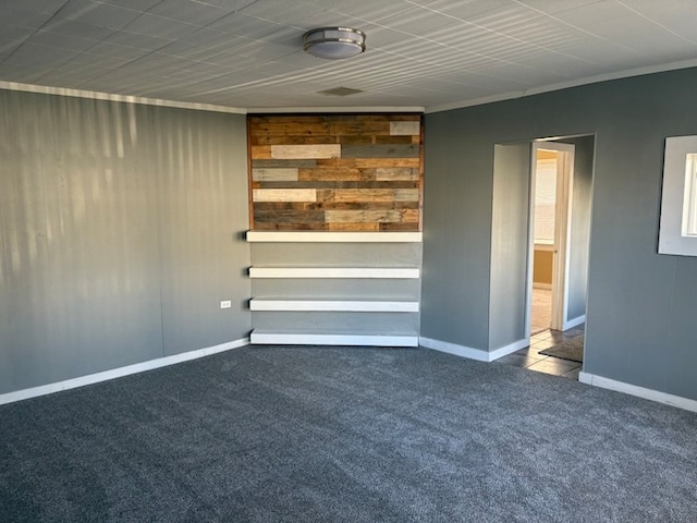 carpeted empty room featuring ornamental molding