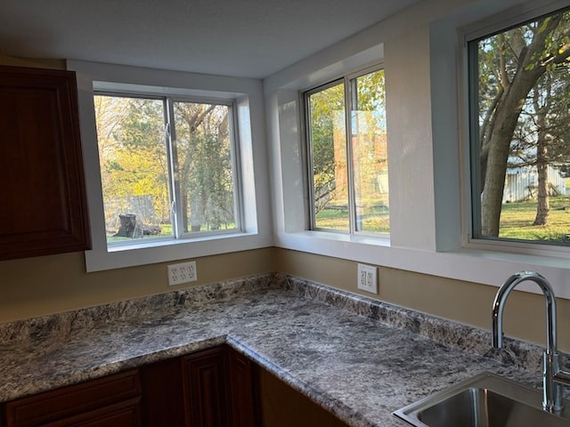 details with light stone countertops and sink