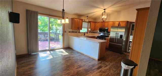 1006 N Koester Dr, Effingham, IL 62401 - kitchen featuring appliances with stainless steel finishes, a peninsula, dark wood-type flooring, light countertops, and lofted ceiling
