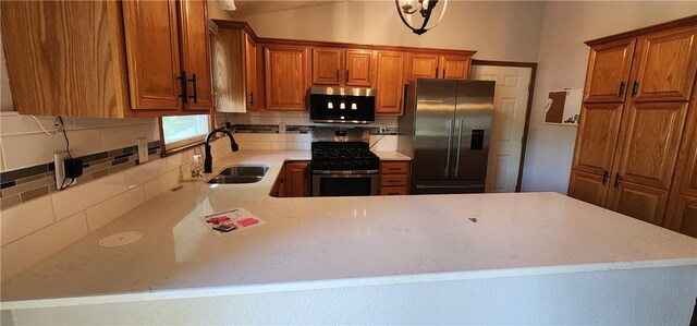 1006 N Koester Dr, Effingham, IL 62401 - kitchen featuring stainless steel appliances, a sink, decorative backsplash, and light countertops