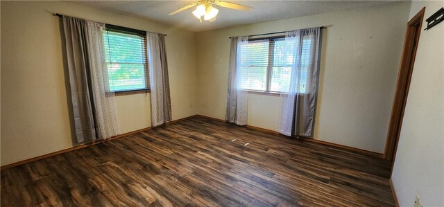1006 N Koester Dr, Effingham, IL 62401 - empty room with dark wood finished floors, a ceiling fan, and baseboards