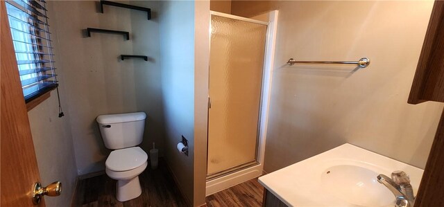 1006 N Koester Dr, Effingham, IL 62401 - bathroom featuring a stall shower, toilet, wood finished floors, and vanity