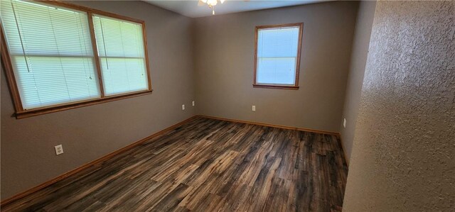 1006 N Koester Dr, Effingham, IL 62401 - empty room featuring dark wood-style flooring, baseboards, and ceiling fan