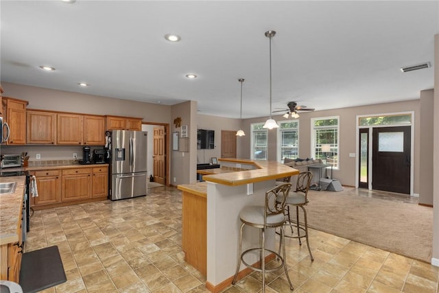 485 County Road 600 N, Neoga, IL 62447 - kitchen featuring stainless steel appliances, light countertops, recessed lighting, a kitchen breakfast bar, and open floor plan