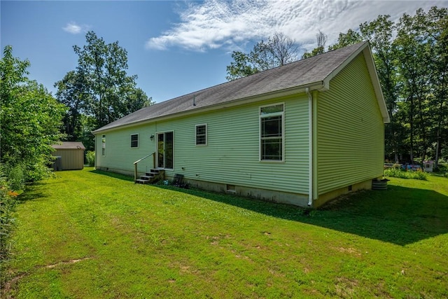 485 County Road 600 N, Neoga, IL 62447 - back of property featuring entry steps, a storage unit, and a lawn