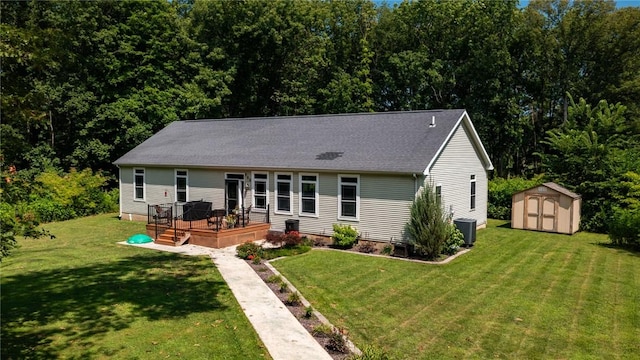 485 County Road 600 N, Neoga, IL 62447 - rear view of property with a storage shed, a wooden deck, a lawn, and roof with shingles