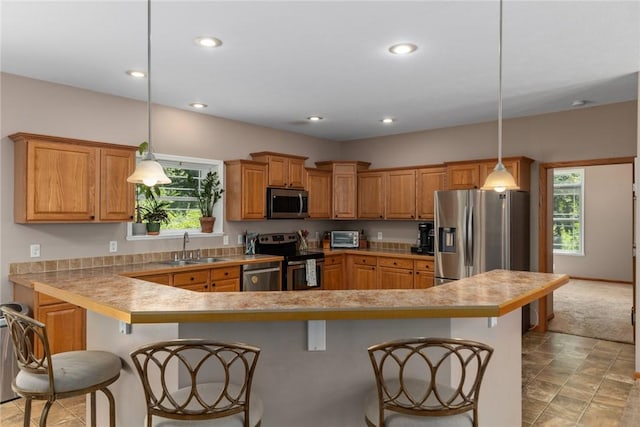 485 County Road 600 N, Neoga, IL 62447 - kitchen with appliances with stainless steel finishes, a kitchen bar, light countertops, recessed lighting, and brown cabinetry