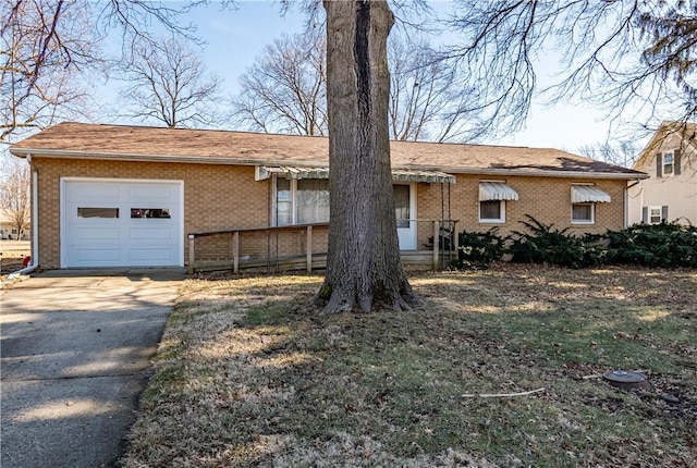 single story home with a garage, brick siding, and driveway