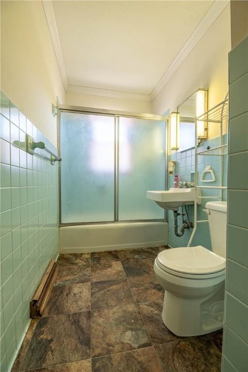 full bathroom featuring toilet, enclosed tub / shower combo, ornamental molding, and tile walls