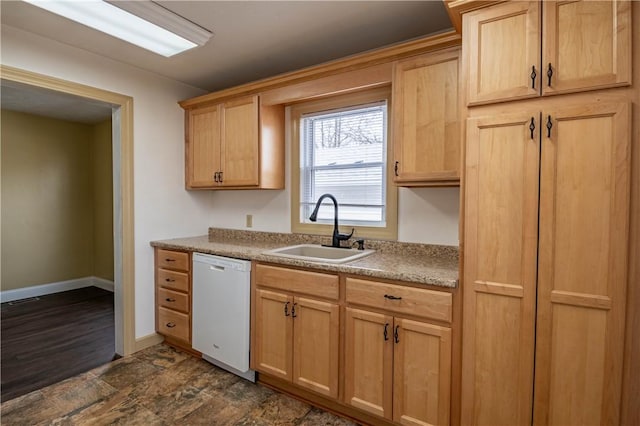 kitchen featuring sink, dishwasher, and light brown cabinets