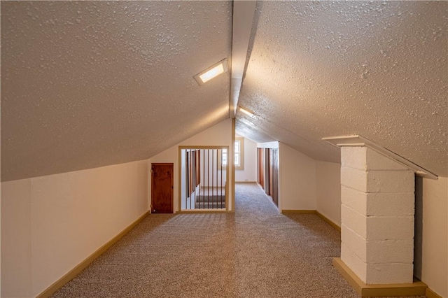 bonus room with light carpet, vaulted ceiling, and a textured ceiling