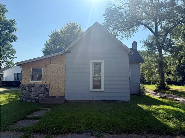 514 Sherman St, Danville, IL 61832 - view of home's exterior with a yard and a chimney