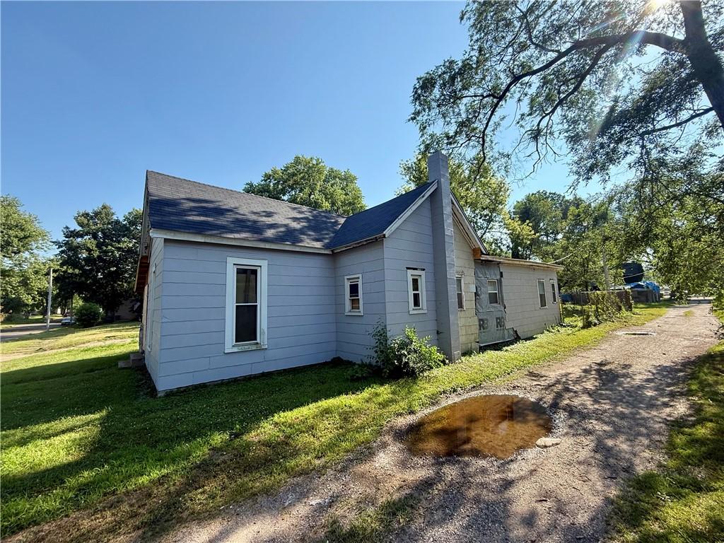 514 Sherman St, Danville, IL 61832 - view of side of home featuring a chimney, a lawn, and a shingled roof