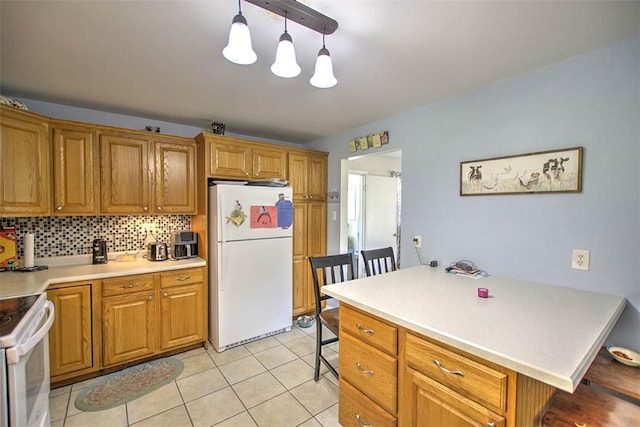 kitchen with light countertops, brown cabinets, and white appliances