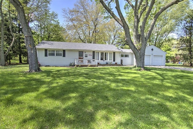 ranch-style house featuring concrete driveway and a front yard