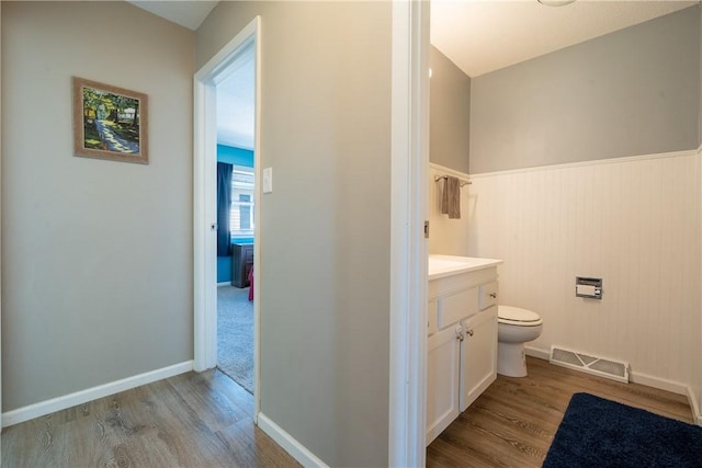 1203 Temple Ave, Effingham, IL 62401 - bathroom featuring wood finished floors, vanity, and a wainscoted wall