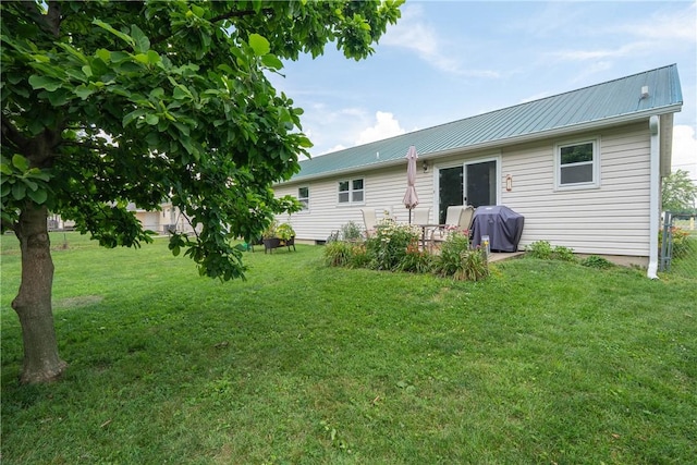 1203 Temple Ave, Effingham, IL 62401 - rear view of property with a lawn and a metal roof
