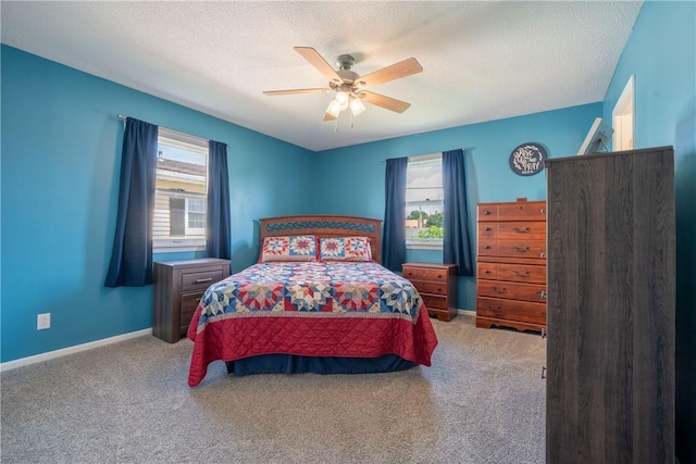 1203 Temple Ave, Effingham, IL 62401 - bedroom with multiple windows, carpet, a textured ceiling, and a ceiling fan