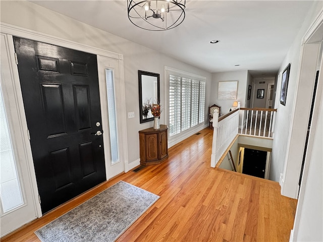 entrance foyer with a chandelier and light wood-type flooring