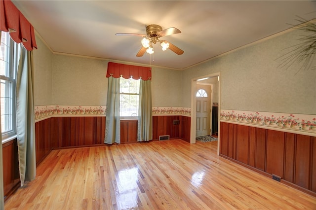 164 S Linden Ave, Decatur, IL 62522 - spare room with healthy amount of natural light, wainscoting, light wood-style floors, ceiling fan, and crown molding