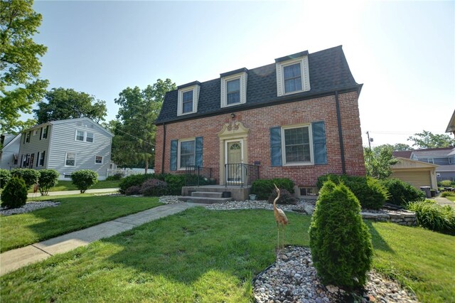 164 S Linden Ave, Decatur, IL 62522 - view of front of house featuring brick siding, mansard roof, roof with shingles, and a front yard