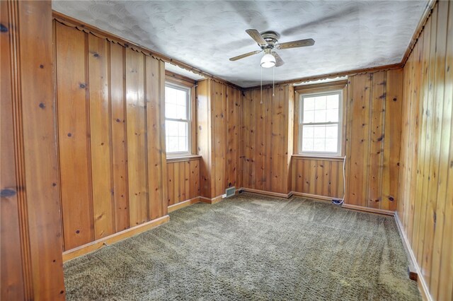 164 S Linden Ave, Decatur, IL 62522 - carpeted empty room with ceiling fan, baseboards, and wooden walls