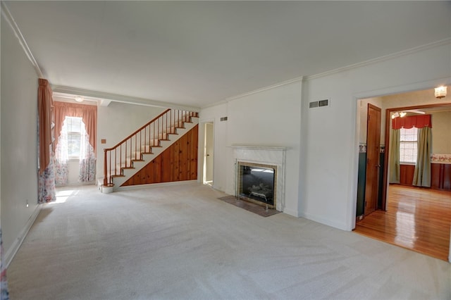 164 S Linden Ave, Decatur, IL 62522 - unfurnished living room featuring ornamental molding, carpet flooring, stairs, a fireplace with flush hearth, and baseboards