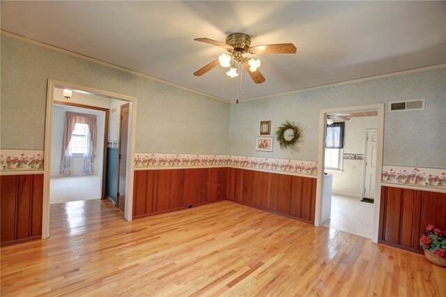 164 S Linden Ave, Decatur, IL 62522 - spare room with light wood-type flooring, ceiling fan, wainscoting, plenty of natural light, and wallpapered walls