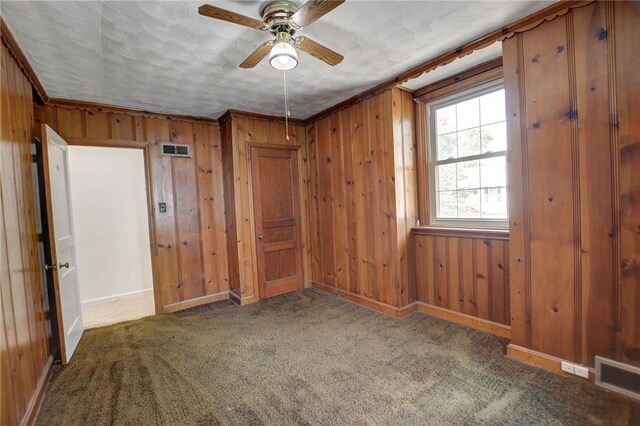 164 S Linden Ave, Decatur, IL 62522 - unfurnished room with a ceiling fan, wooden walls, baseboards, and carpet flooring
