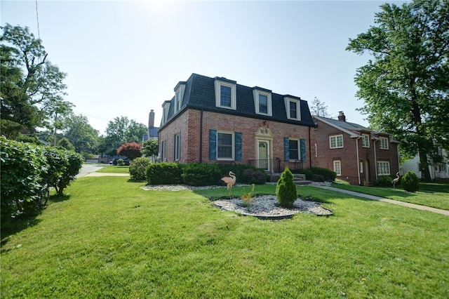 164 S Linden Ave, Decatur, IL 62522 - view of front of home with mansard roof, brick siding, a front lawn, and roof with shingles