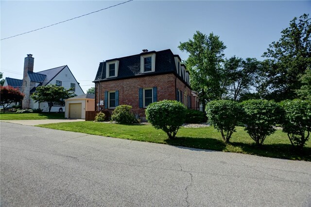164 S Linden Ave, Decatur, IL 62522 - view of front facade with brick siding, mansard roof, a front yard, concrete driveway, and a garage