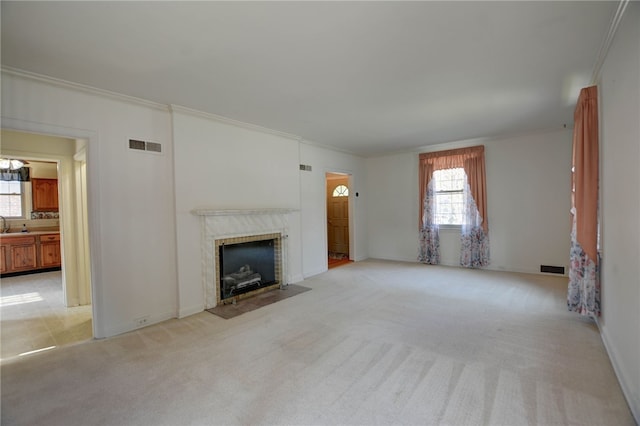 164 S Linden Ave, Decatur, IL 62522 - unfurnished living room featuring ornamental molding, light colored carpet, and a fireplace with flush hearth