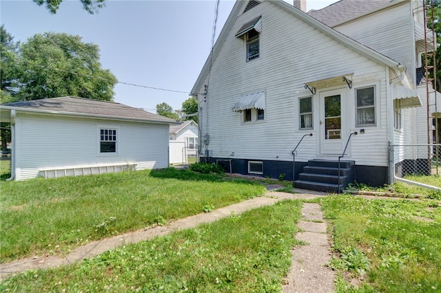319 N Macon St, Moweaqua, IL 62550 - rear view of house featuring a chimney and entry steps