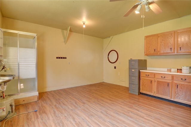 319 N Macon St, Moweaqua, IL 62550 - kitchen featuring light wood-type flooring, ceiling fan, and light countertops