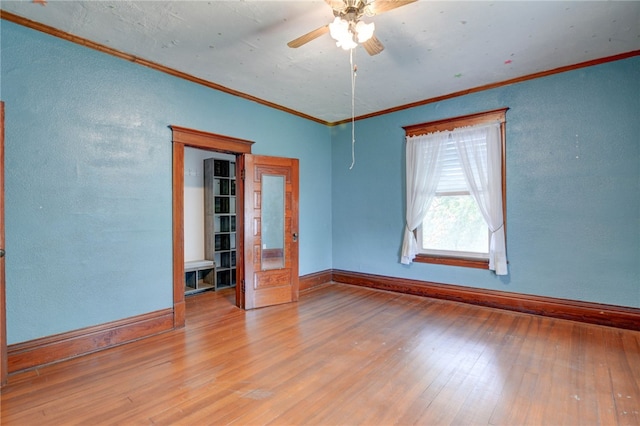 319 N Macon St, Moweaqua, IL 62550 - unfurnished room with crown molding, hardwood / wood-style floors, a ceiling fan, and a textured wall