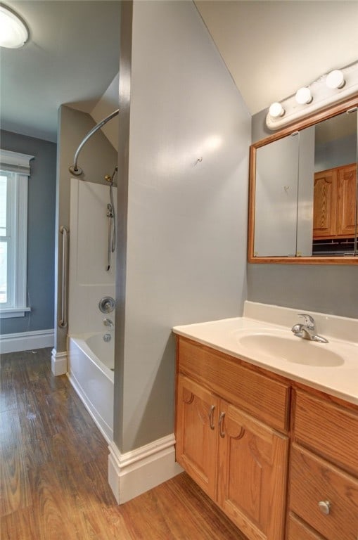319 N Macon St, Moweaqua, IL 62550 - bathroom with vanity, wood finished floors, shower / bathtub combination, and lofted ceiling
