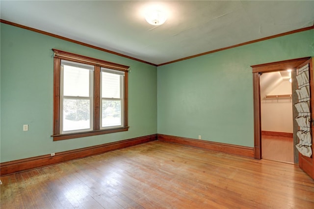 319 N Macon St, Moweaqua, IL 62550 - spare room featuring light wood-style floors and crown molding