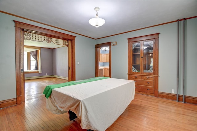 319 N Macon St, Moweaqua, IL 62550 - bedroom with light wood-type flooring, crown molding, and a baseboard heating unit