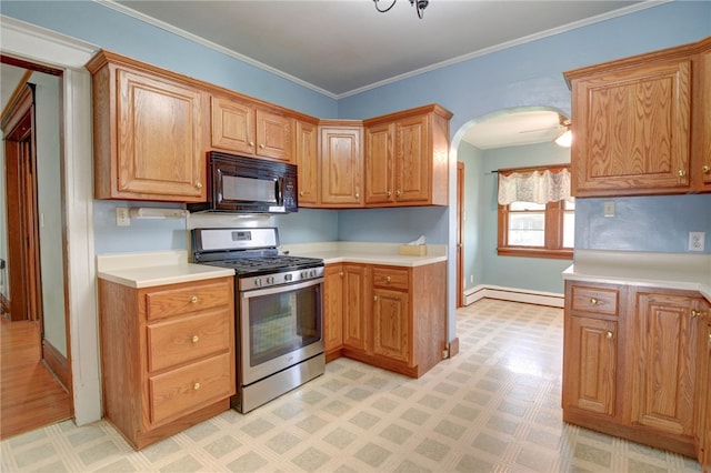319 N Macon St, Moweaqua, IL 62550 - kitchen featuring black microwave, gas range, baseboard heating, light floors, and light countertops