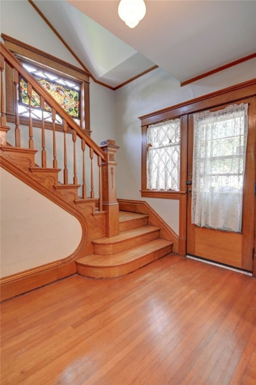 319 N Macon St, Moweaqua, IL 62550 - foyer entrance featuring stairs, wood finished floors, ornamental molding, and vaulted ceiling