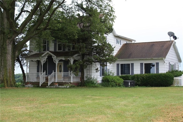 235 E 150 N Rd, Hammond, IL 61929 - view of front of home with covered porch, a front yard, and roof with shingles