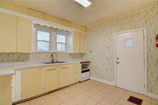 kitchen featuring sink and light tile patterned floors