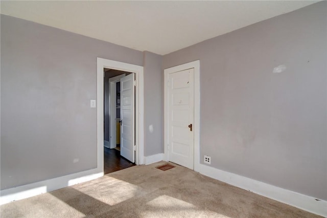 unfurnished room featuring dark colored carpet