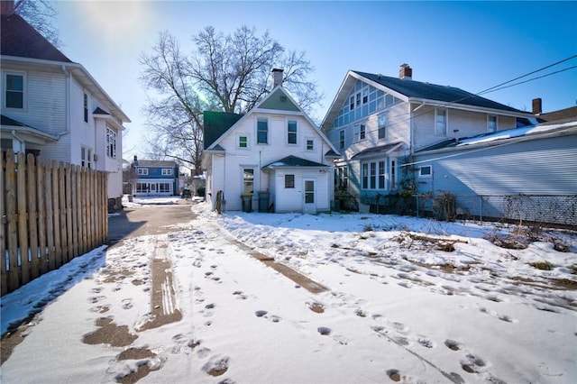 view of snow covered rear of property