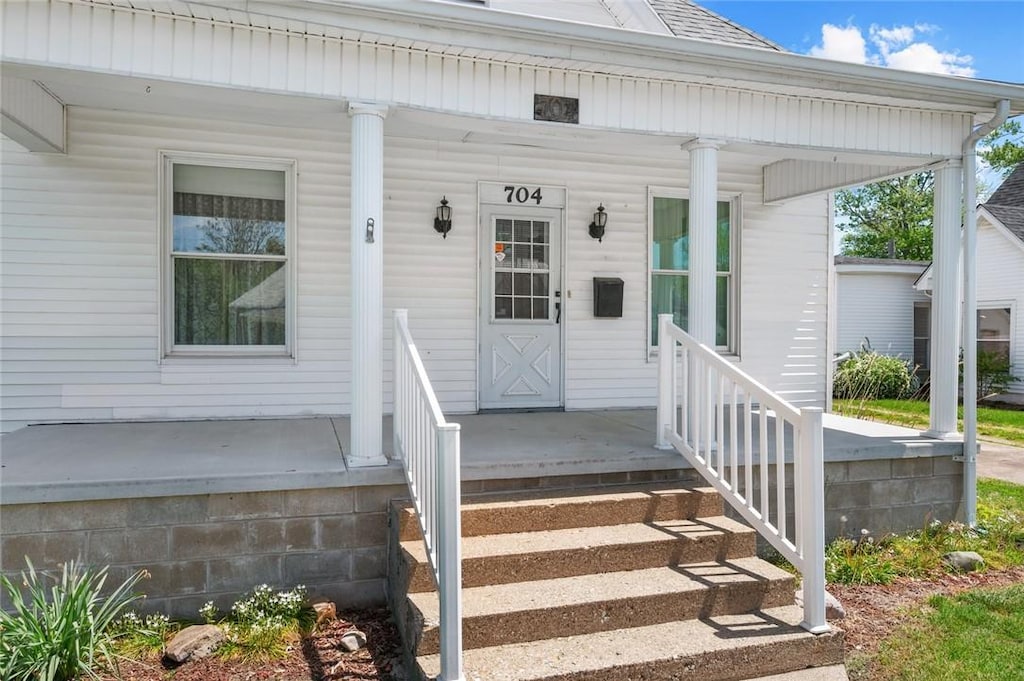 704 N Main St, Paris, IL 61944 - doorway to property with covered porch and a shingled roof