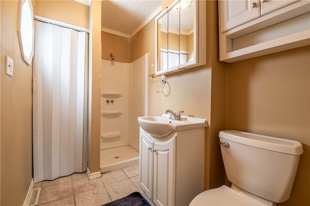 bathroom featuring a shower, ornamental molding, vanity, toilet, and tile patterned floors