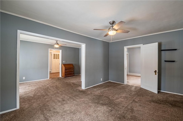 empty room with crown molding, ceiling fan, and carpet flooring