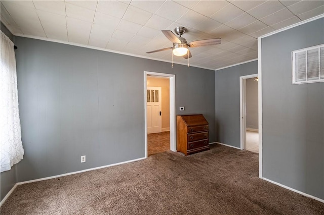 unfurnished bedroom with ornamental molding, ceiling fan, and dark colored carpet