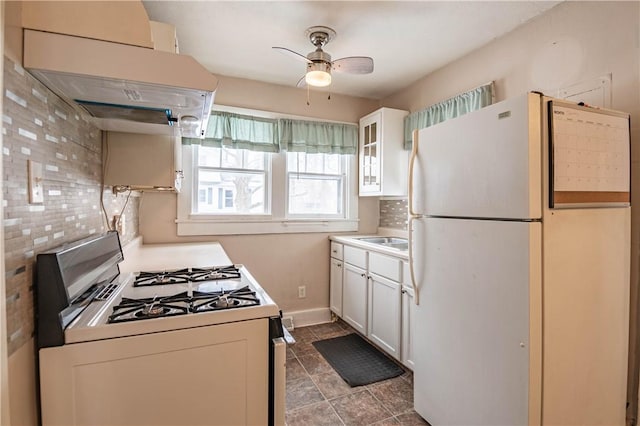 kitchen featuring sink, white appliances, ceiling fan, white cabinetry, and range hood