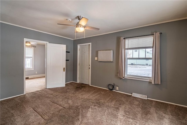 unfurnished room with crown molding, ceiling fan, and carpet flooring